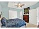 Bedroom with a ceiling fan, ample closet space, and a colorful quilt at 622 E 10Th St # 310, Indianapolis, IN 46202