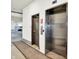 Apartment building elevator access featuring a stainless steel elevator and service doors at 622 E 10Th St # 310, Indianapolis, IN 46202