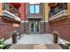 Welcoming building entrance with brickwork, stylish seating, and planters, offering a modern and appealing arrival at 622 E 10Th St # 310, Indianapolis, IN 46202