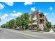 Street view of the attractive building showcasing architectural details, balconies, and a well-maintained landscape at 622 E 10Th St # 310, Indianapolis, IN 46202