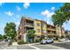 Corner view of the building with brick accents, offering balconies and street views, complemented by lush greenery at 622 E 10Th St # 310, Indianapolis, IN 46202