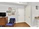 Hallway with hardwood floors, white walls, and colorful artwork creating an inviting entrance at 622 E 10Th St # 310, Indianapolis, IN 46202