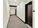 Well-lit hallway featuring modern carpeting and neutral walls, leading to various units within the building at 622 E 10Th St # 310, Indianapolis, IN 46202