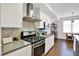 Modern kitchen features stainless steel appliances, white cabinetry, and eat in dining space at 622 E 10Th St # 310, Indianapolis, IN 46202