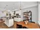 Bright open kitchen with stainless appliances, stylish bar stools, and a view of the dining area at 622 E 10Th St # 310, Indianapolis, IN 46202