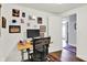 Bright and inviting office space with an adjustable desk, leading to a hallway at 622 E 10Th St # 310, Indianapolis, IN 46202