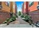 Inviting walkway between buildings, adorned with lush greenery and planters, providing a serene and pedestrian-friendly path at 622 E 10Th St # 310, Indianapolis, IN 46202