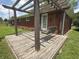 Cozy back patio with brick exterior, wooden pergola, and a porch swing at 6237 E Lynn Dr, Mooresville, IN 46158