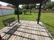 The backyard features a wooden deck with a swing and an arbor covered with climbing plants at 6237 E Lynn Dr, Mooresville, IN 46158