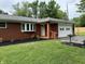 Well maintained brick home featuring a manicured lawn, flowerbeds, attached garage and neutral trim at 6237 E Lynn Dr, Mooresville, IN 46158