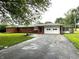 Charming brick ranch home featuring an attached two car garage and mature trees at 6237 E Lynn Dr, Mooresville, IN 46158