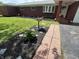 Beautifully landscaped front yard with fresh mulch and vibrant flower beds at 6237 E Lynn Dr, Mooresville, IN 46158