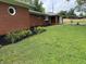Charming brick home featuring a well-manicured lawn and vibrant landscaping with yellow flowers at 6237 E Lynn Dr, Mooresville, IN 46158