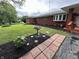 Charming brick home with manicured front yard, flower beds, and a walkway leading to the inviting front porch at 6237 E Lynn Dr, Mooresville, IN 46158