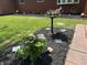 Close-up of beautifully landscaped front yard with a bird bath and lush plants at 6237 E Lynn Dr, Mooresville, IN 46158