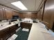 Traditional kitchen featuring wood cabinetry, tile backsplash, and an efficient layout at 6237 E Lynn Dr, Mooresville, IN 46158