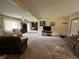 Inviting living area with carpet, natural light, TV, and access to the dining area at 6237 E Lynn Dr, Mooresville, IN 46158