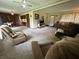 Spacious carpeted living room featuring neutral tones, a ceiling fan, and lots of seating at 6237 E Lynn Dr, Mooresville, IN 46158