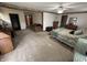 Spacious main bedroom featuring neutral walls, carpeting, ceiling fan, and a doorway to the living room at 6237 E Lynn Dr, Mooresville, IN 46158