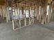 Framed living room with wall studs, visible ductwork, and several windows at 637 Firefly Ct, Greenfield, IN 46140