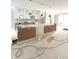 Large, bright kitchen features white cabinets, center island, modern lighting, and stainless appliances at 7309 Bayview Run, McCordsville, IN 46055