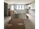 Unfinished kitchen with white cabinets, neutral walls, window, and boxes on the floor at 7313 Bayview Run, McCordsville, IN 46055