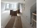 Spacious unfinished living room with boxes, neutral paint, and staircase with wooden railing at 7313 Bayview Run, McCordsville, IN 46055