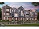 A row of new townhomes shows varied facades with brick and siding, enhancing the community's curb appeal at 7351 Bayview Run, McCordsville, IN 46055