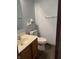 Bathroom with a wooden cabinet sink and toilet. The bathroom features light blue paint at 7536 Briarstone Dr, Indianapolis, IN 46227