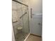 Modern bathroom shower with glass door, tile surround, supportive handrails, and shower seat at 7536 Briarstone Dr, Indianapolis, IN 46227