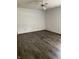 A spacious and bright bedroom featuring laminate flooring and neutral paint scheme at 7536 Briarstone Dr, Indianapolis, IN 46227