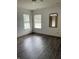 Bright bedroom with two windows, hardwood floors, and natural light at 7536 Briarstone Dr, Indianapolis, IN 46227