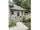 A fenced-in side entrance featuring tidy landscaping and a brick exterior with stone-paved path at 7536 Briarstone Dr, Indianapolis, IN 46227