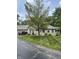 A well-maintained home with mature trees, a lush lawn, and a brick exterior with attached garage at 7536 Briarstone Dr, Indianapolis, IN 46227