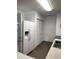 Efficient kitchen space with white appliances, ample storage, and laminate countertops, plus laminate flooring at 7536 Briarstone Dr, Indianapolis, IN 46227