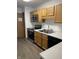 Functional kitchen with stainless steel appliances, wood cabinets, laminate countertops, and tile backsplash at 7536 Briarstone Dr, Indianapolis, IN 46227