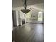 Bright living room featuring fireplace, hardwood floors, vaulted ceiling, and large arched windows at 7536 Briarstone Dr, Indianapolis, IN 46227