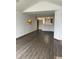 Open concept living area with hardwood flooring, abundant light, and a pass-through to the kitchen at 7536 Briarstone Dr, Indianapolis, IN 46227