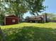 Expansive backyard featuring a wooden deck, storage shed, and lush green lawn perfect for outdoor activities at 7607 Ardwell Ct, Indianapolis, IN 46237
