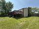 Spacious backyard showcasing a raised wooden deck and mature trees creating a private outdoor space at 7607 Ardwell Ct, Indianapolis, IN 46237
