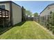 Narrow backyard featuring green lawn between the home and wood fence, providing a private outdoor space at 7607 Ardwell Ct, Indianapolis, IN 46237
