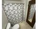 Full bathroom featuring a shower with patterned curtain and natural light at 7607 Ardwell Ct, Indianapolis, IN 46237