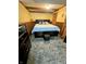 Cozy bedroom featuring a large bed, wood trim, and a patterned rug at 7607 Ardwell Ct, Indianapolis, IN 46237