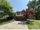Charming split-level home featuring a two-car garage and mature trees in a well-manicured yard at 7607 Ardwell Ct, Indianapolis, IN 46237