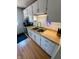 Functional kitchen sink area with modern faucet, white cabinets, and laminate countertops at 7607 Ardwell Ct, Indianapolis, IN 46237