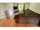 Upstairs view of the open living area with large sofa, hardwood floors, and natural light at 7607 Ardwell Ct, Indianapolis, IN 46237
