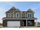 Two-story home showcasing a brick and siding exterior with a two-car garage and a welcoming front porch at 764 Parker Ln, Westfield, IN 46074