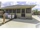 View of the backyard with a concrete patio, a deck, a grill, and a screened back porch at 7741 Long Branch Dr, Indianapolis, IN 46259