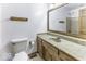 Bright bathroom featuring a wood vanity, a stone countertop, and a large framed mirror at 7741 Long Branch Dr, Indianapolis, IN 46259