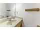 Bathroom with a single sink vanity and mirror with a light colored countertop and oak cabinets at 7741 Long Branch Dr, Indianapolis, IN 46259